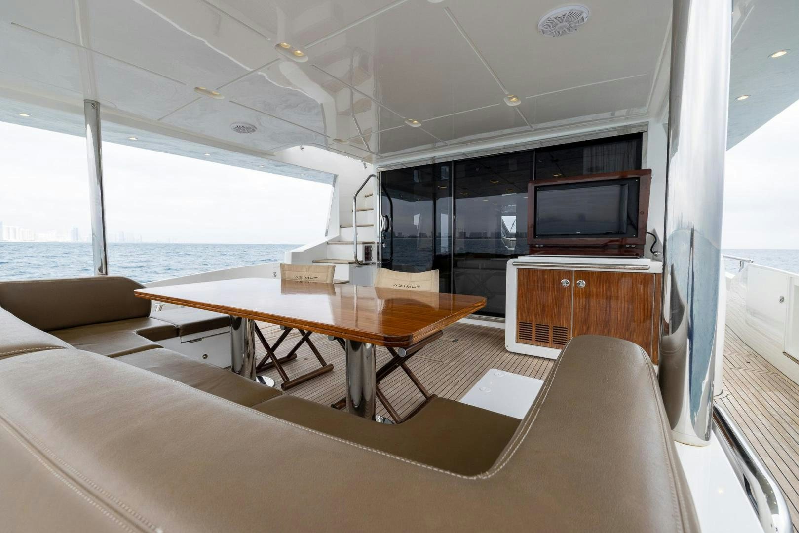 a room with a table and tv aboard HAPPY HOURS Yacht for Sale