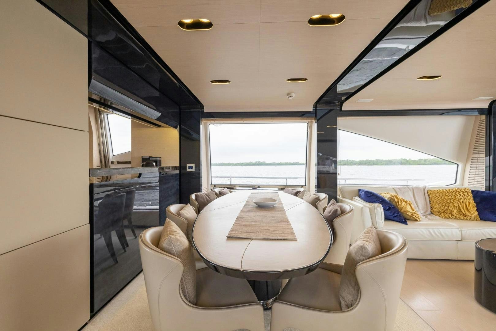 a room with a couch and a table and a large window aboard HAPPY HOURS Yacht for Sale
