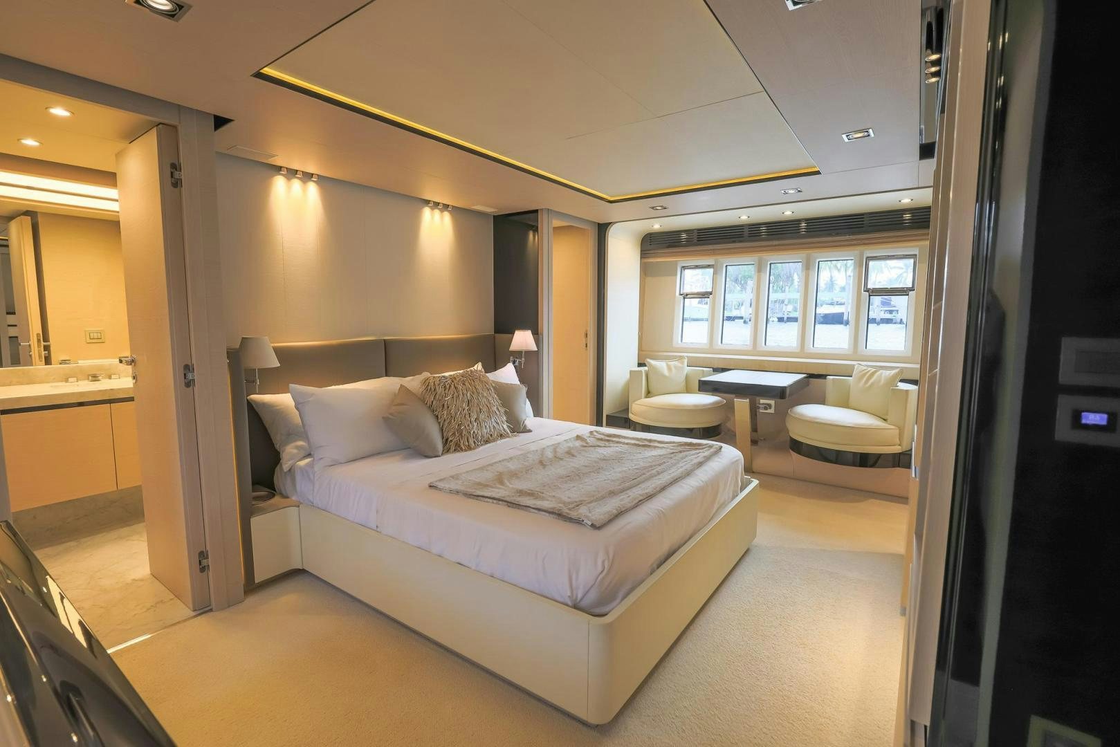 a bedroom with a bed and a table aboard HAPPY HOURS Yacht for Sale
