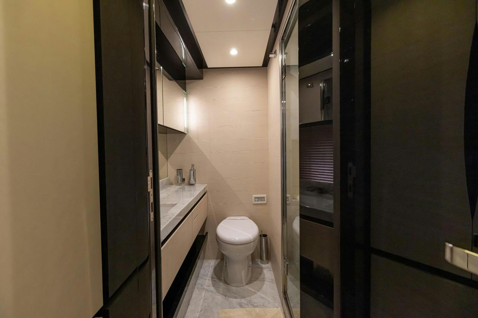 a bathroom with a toilet and a sink aboard HAPPY HOURS Yacht for Sale