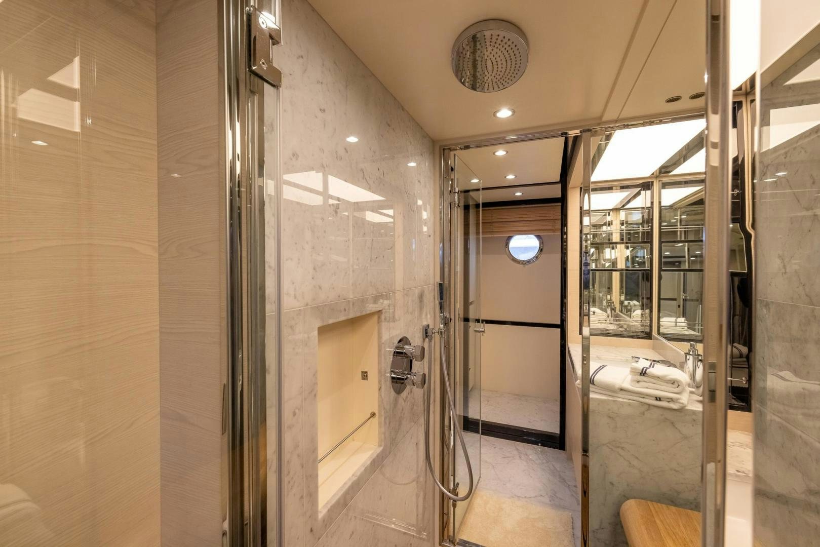 a bathroom with glass doors aboard HAPPY HOURS Yacht for Sale