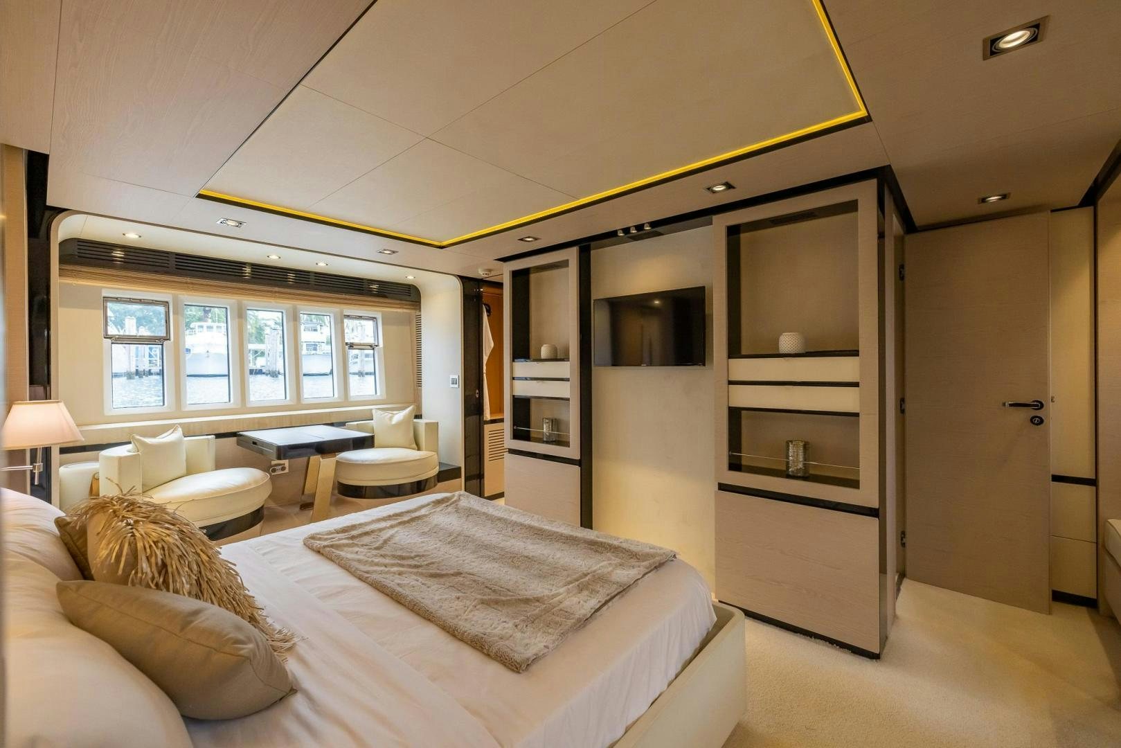 a bedroom with a bed and a desk aboard HAPPY HOURS Yacht for Sale