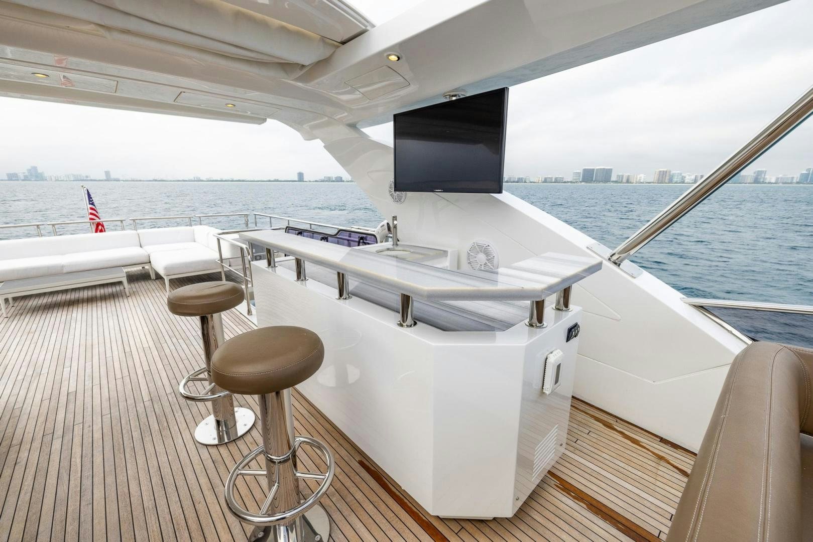 a large white kitchen with a black screen on the side aboard HAPPY HOURS Yacht for Sale