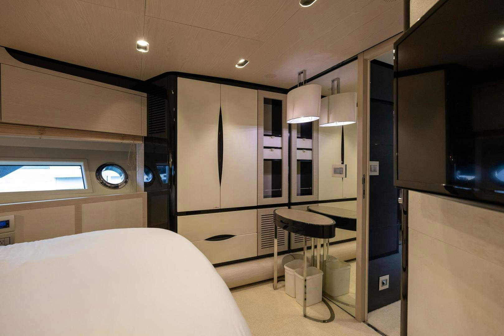 a bedroom with a bed and desk aboard HAPPY HOURS Yacht for Sale