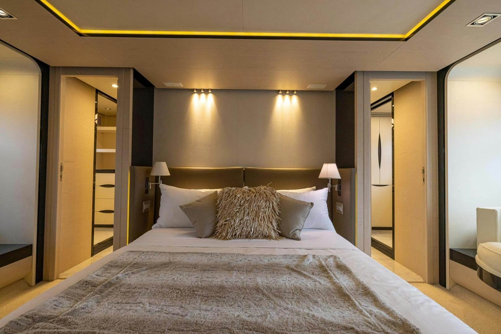 a large bed with a large headboard and a large mirror aboard HAPPY HOURS Yacht for Sale