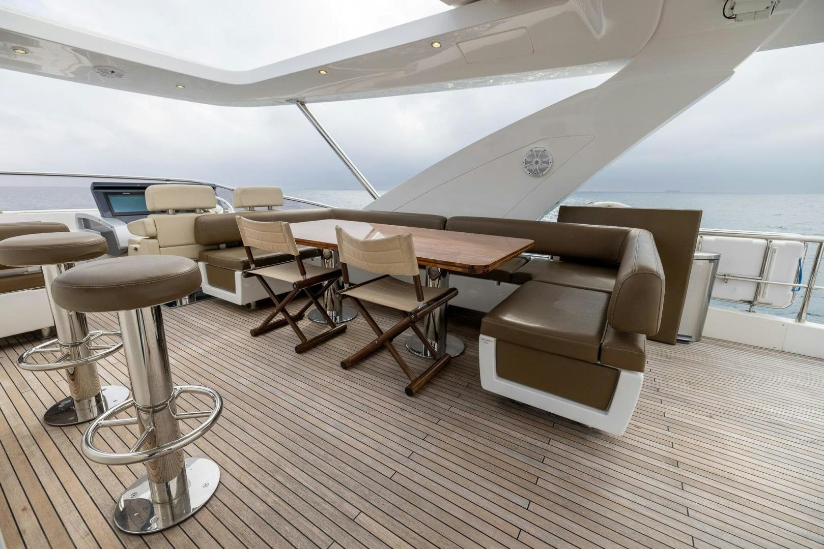 a room with a table chairs and a couch aboard HAPPY HOURS Yacht for Sale