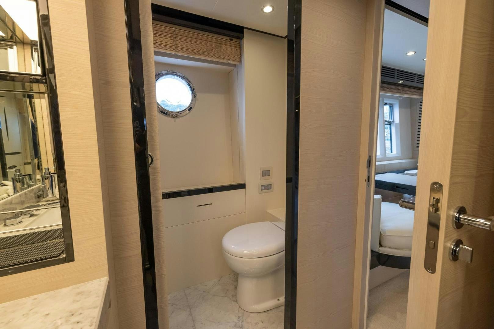a bathroom with a toilet and a mirror aboard HAPPY HOURS Yacht for Sale