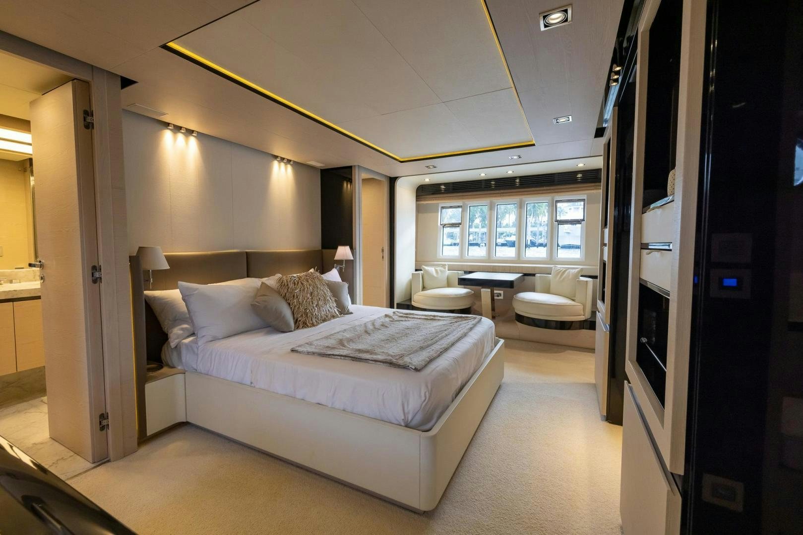 a bedroom with a bed and a desk aboard HAPPY HOURS Yacht for Sale