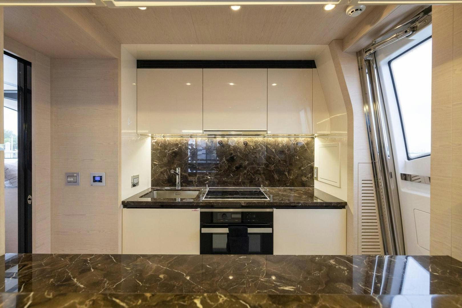 a kitchen with a marble counter top aboard HAPPY HOURS Yacht for Sale