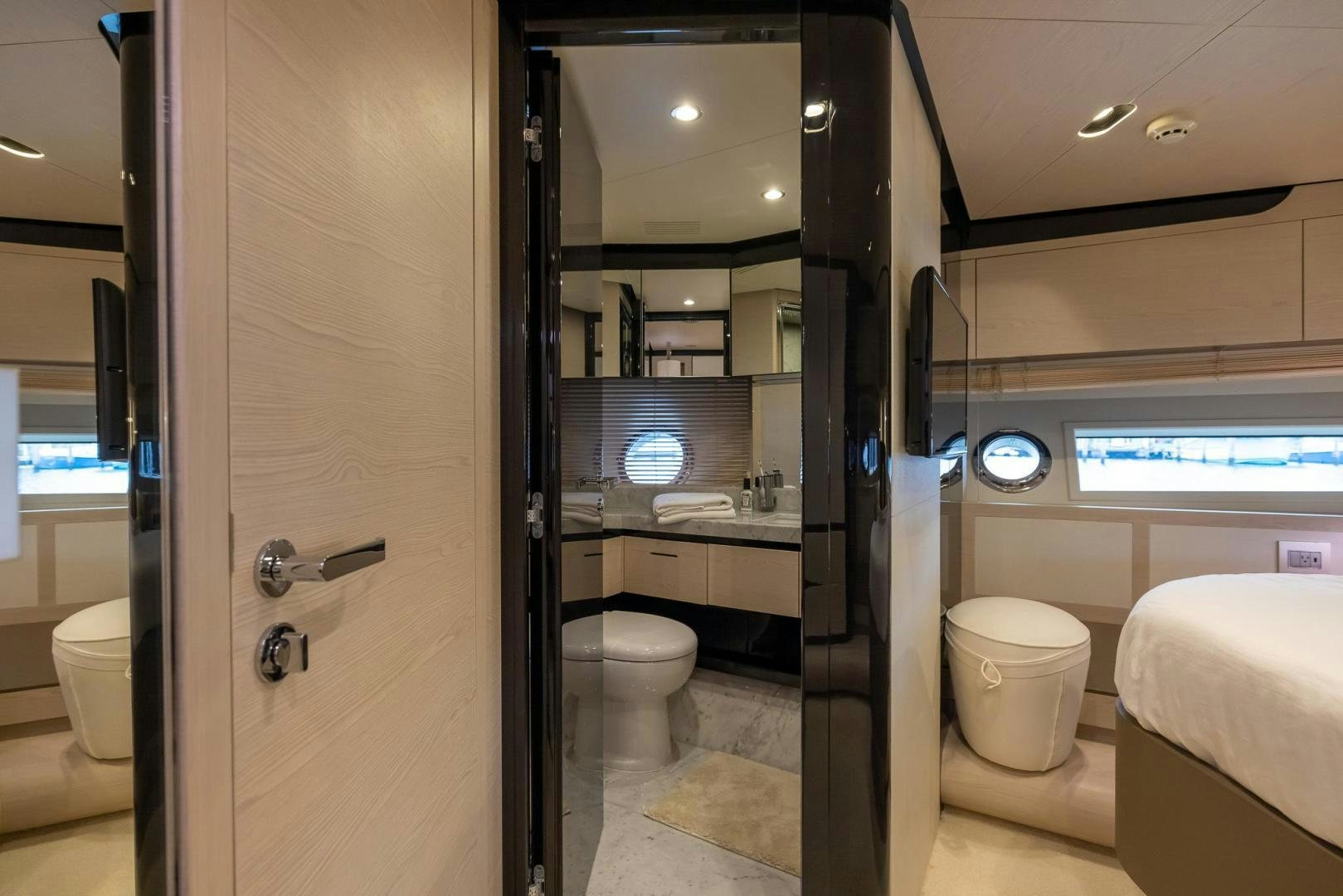 a bathroom with a sink toilet and a mirror aboard HAPPY HOURS Yacht for Sale