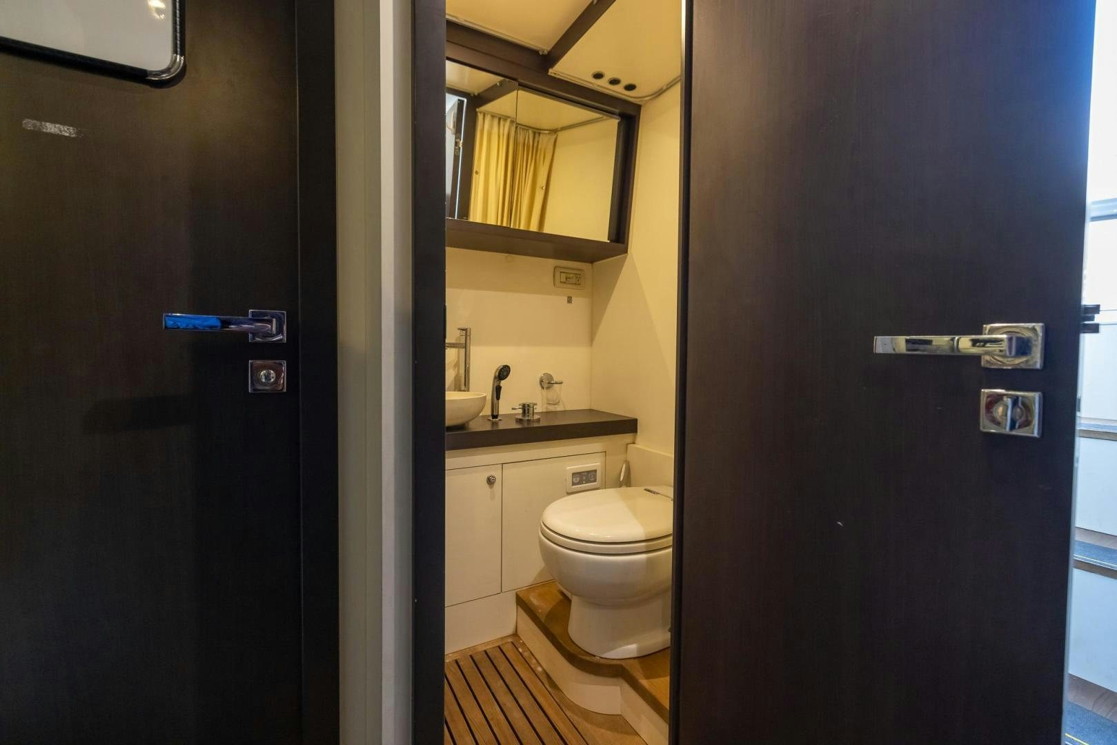 a bathroom with a black door aboard HAPPY HOURS Yacht for Sale
