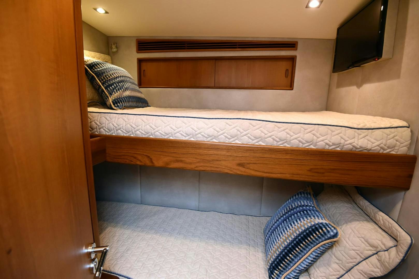 a bed with a wood headboard aboard MY LYNN Yacht for Sale