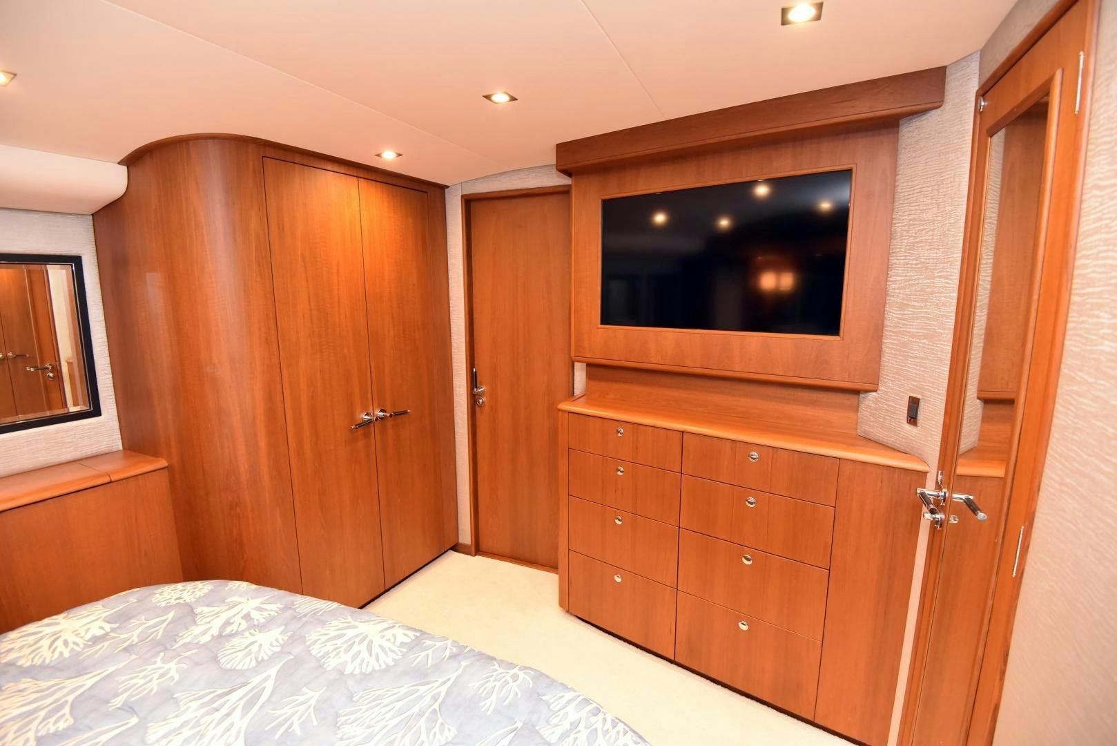 a bedroom with a bed and a television aboard MY LYNN Yacht for Sale