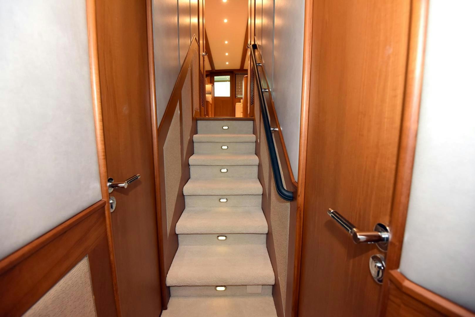a wooden staircase with a wood door aboard MY LYNN Yacht for Sale