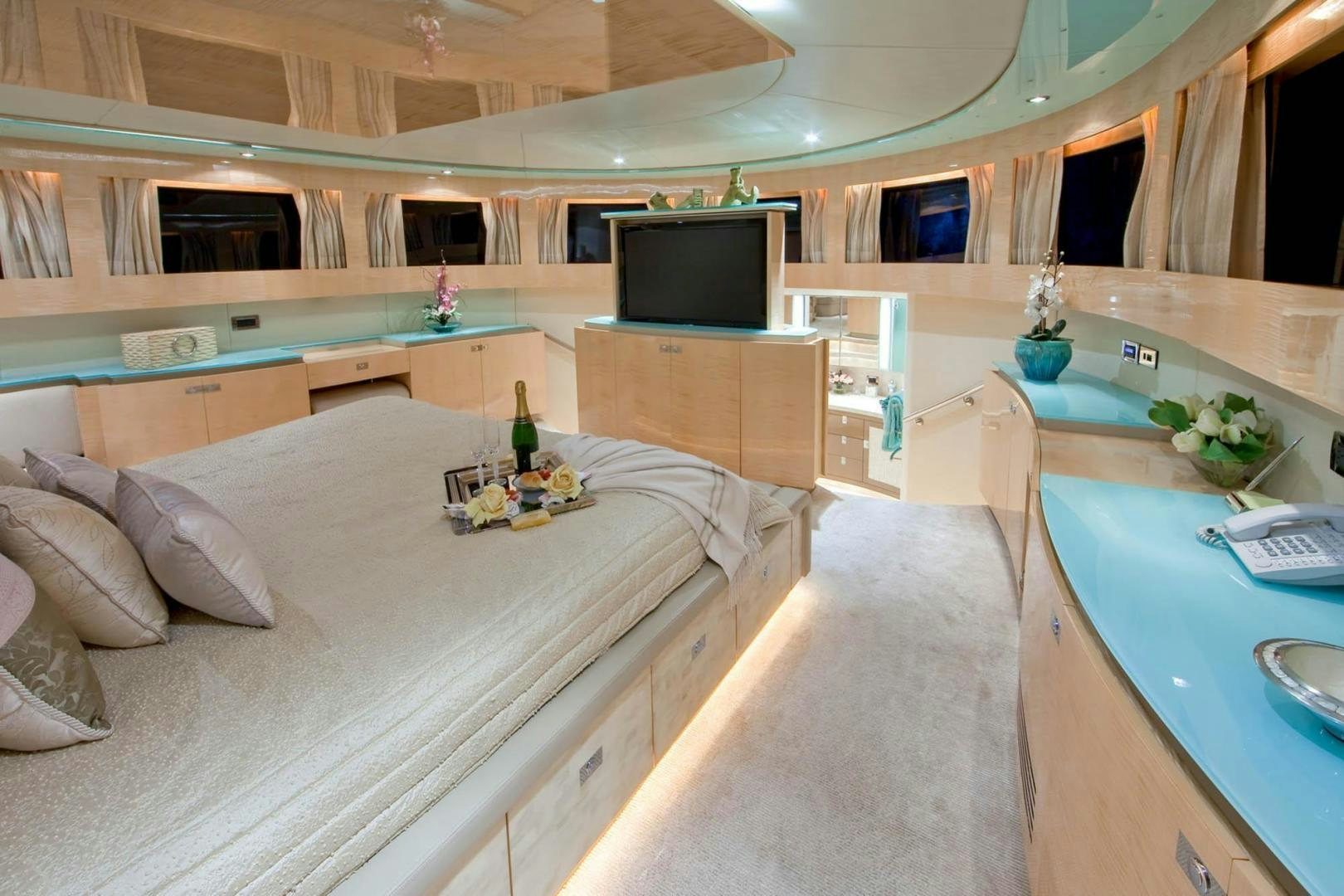 a room with a bed and a television aboard INCEPTION Yacht for Sale