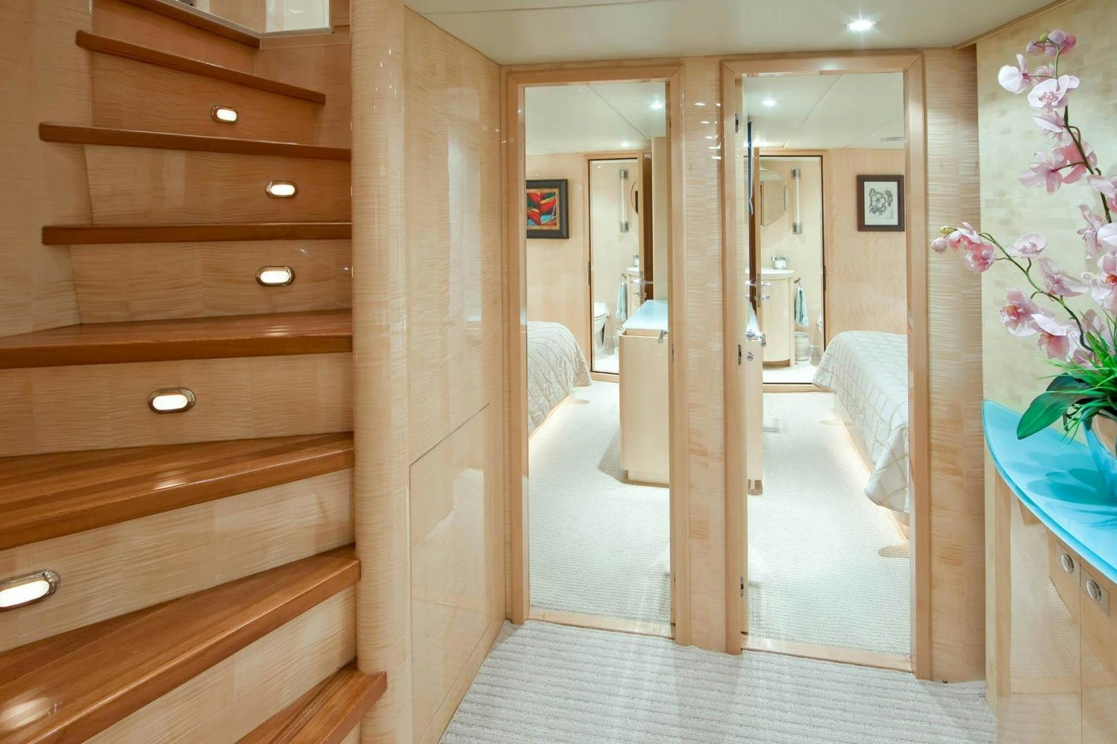 a room with a wood door and a wood cabinet with drawers aboard INCEPTION Yacht for Sale