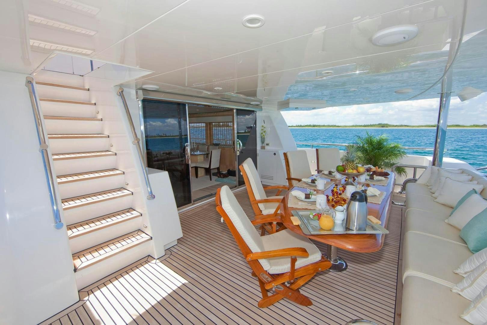 a boat with a table and chairs aboard INCEPTION Yacht for Sale