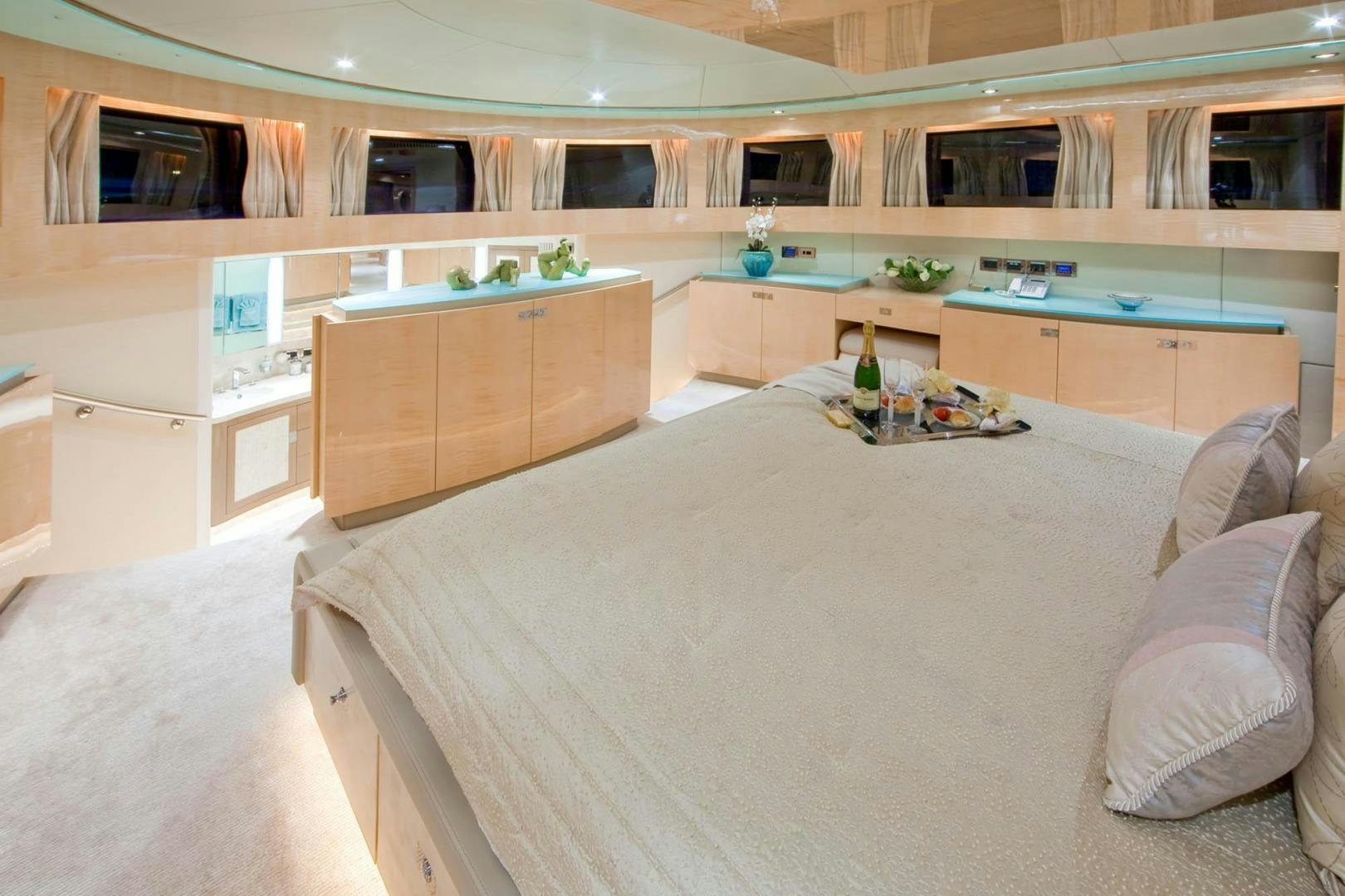 a room with a bed and a desk aboard INCEPTION Yacht for Sale
