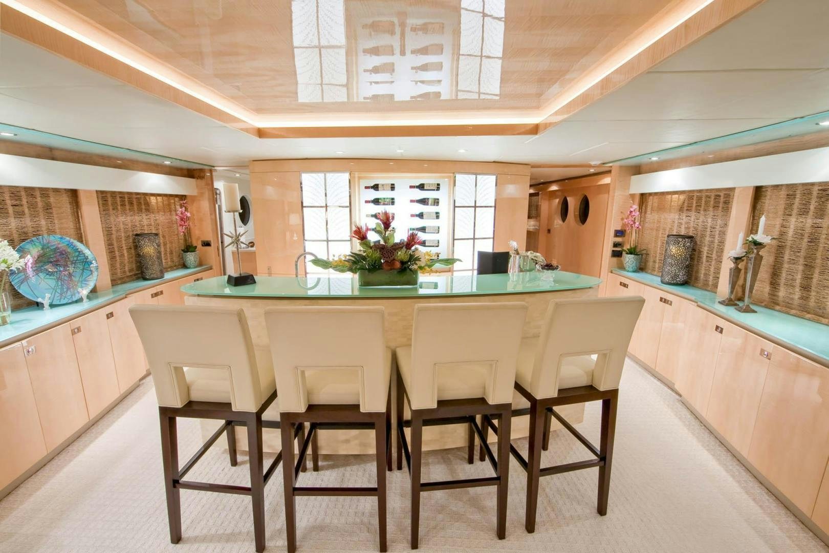 a kitchen with a table and chairs aboard INCEPTION Yacht for Sale