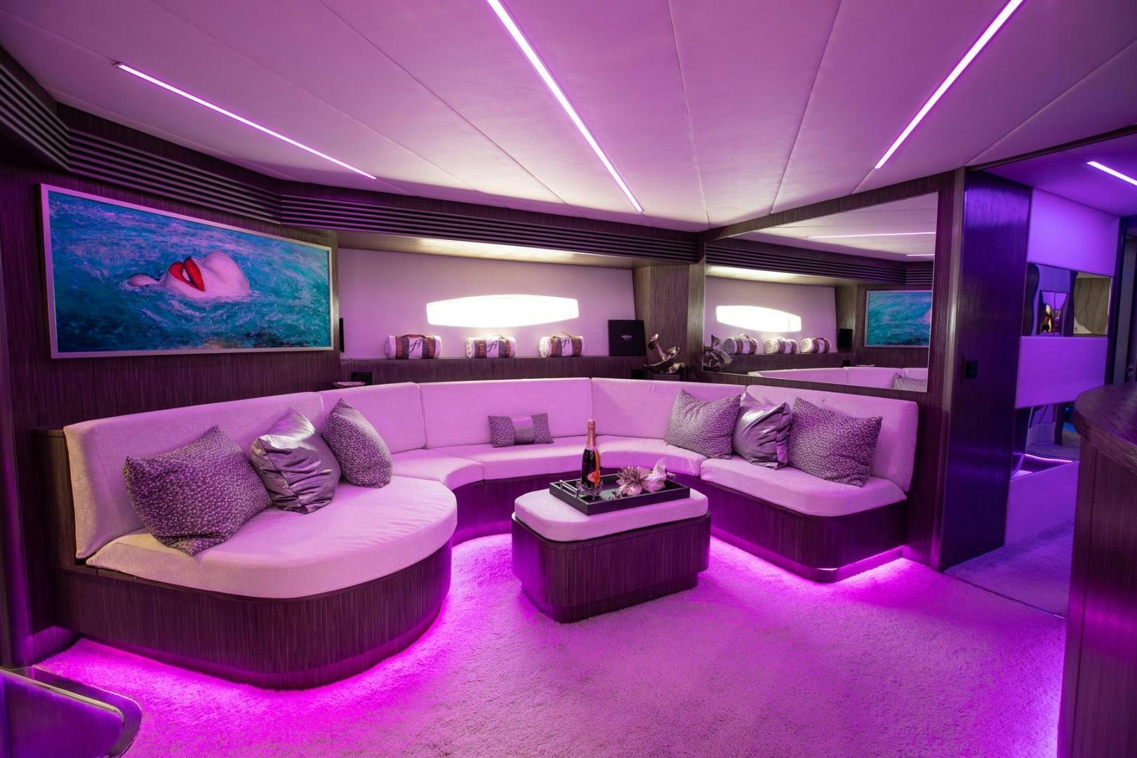 a large room with a couch and a tv aboard AMORA Yacht for Sale