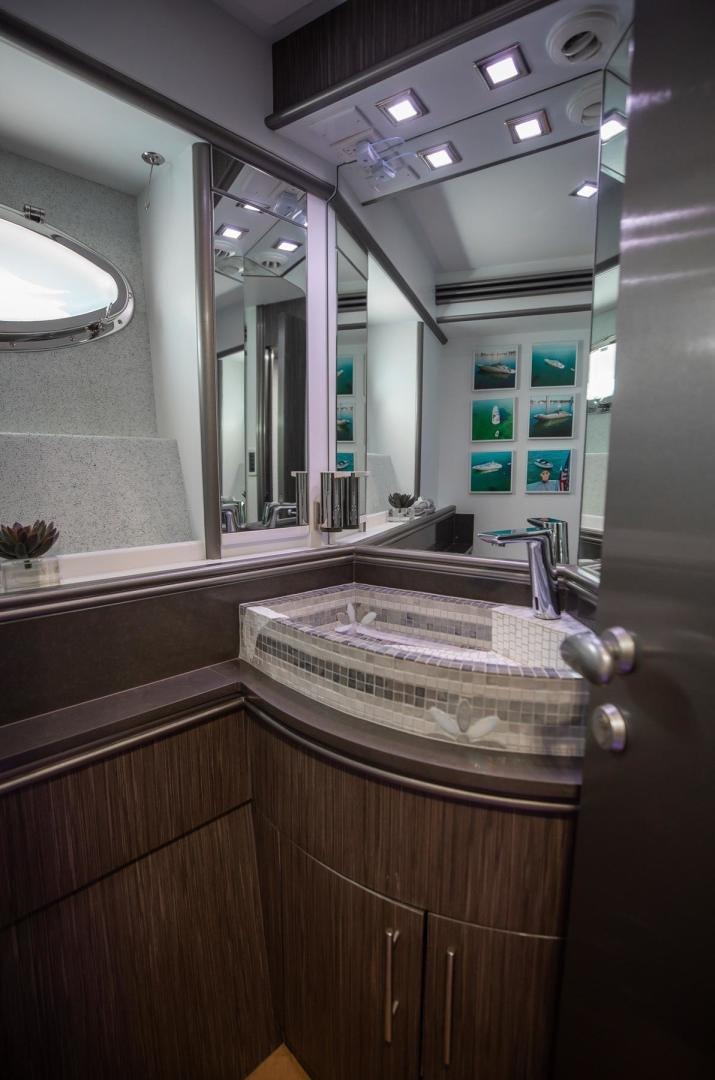 a bathroom with a large mirror aboard AMORA Yacht for Sale