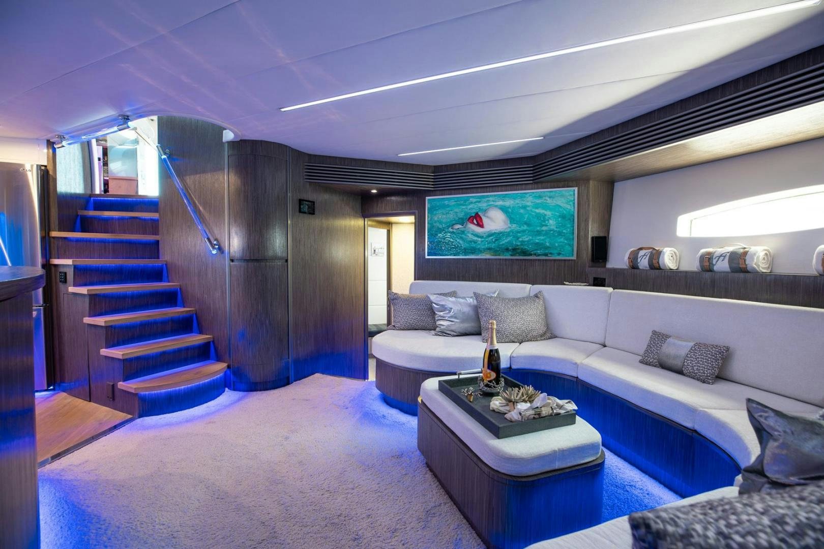 a living room with a large staircase aboard AMORA Yacht for Sale