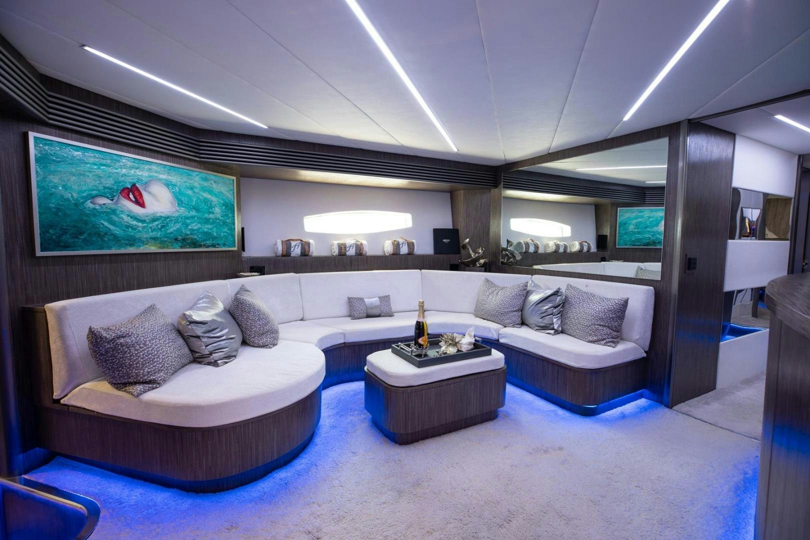 a living room with a large screen aboard AMORA Yacht for Sale