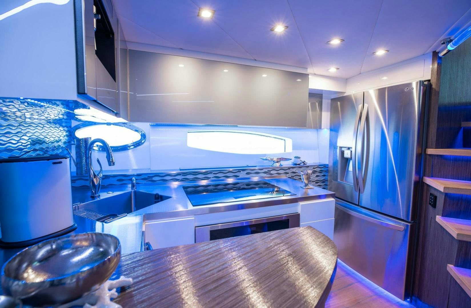 a kitchen with a large island aboard AMORA Yacht for Sale