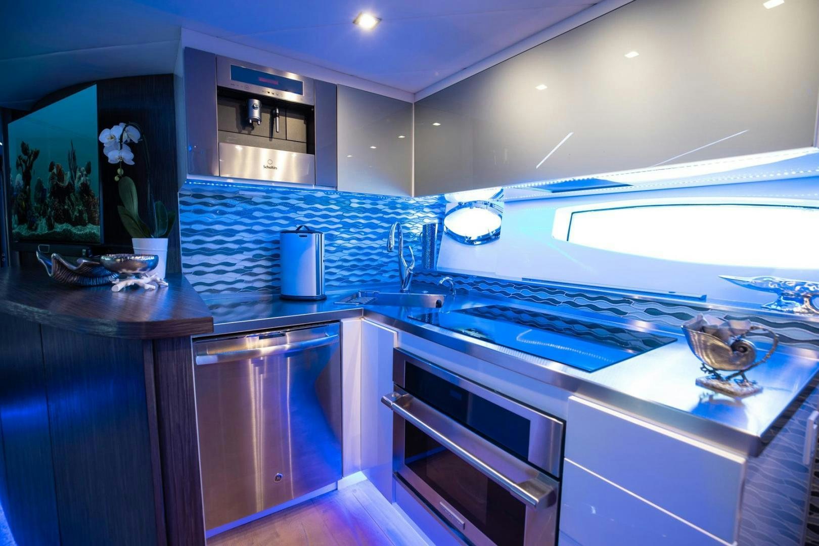 a kitchen with a sink and a large window aboard AMORA Yacht for Sale
