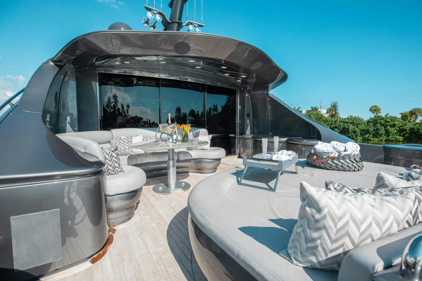 a white bed next to a white car aboard AMORA Yacht for Sale