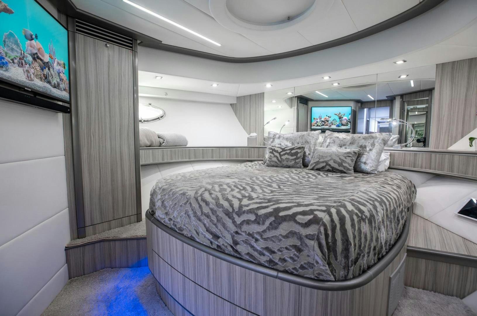 a room with a bed and a television aboard AMORA Yacht for Sale