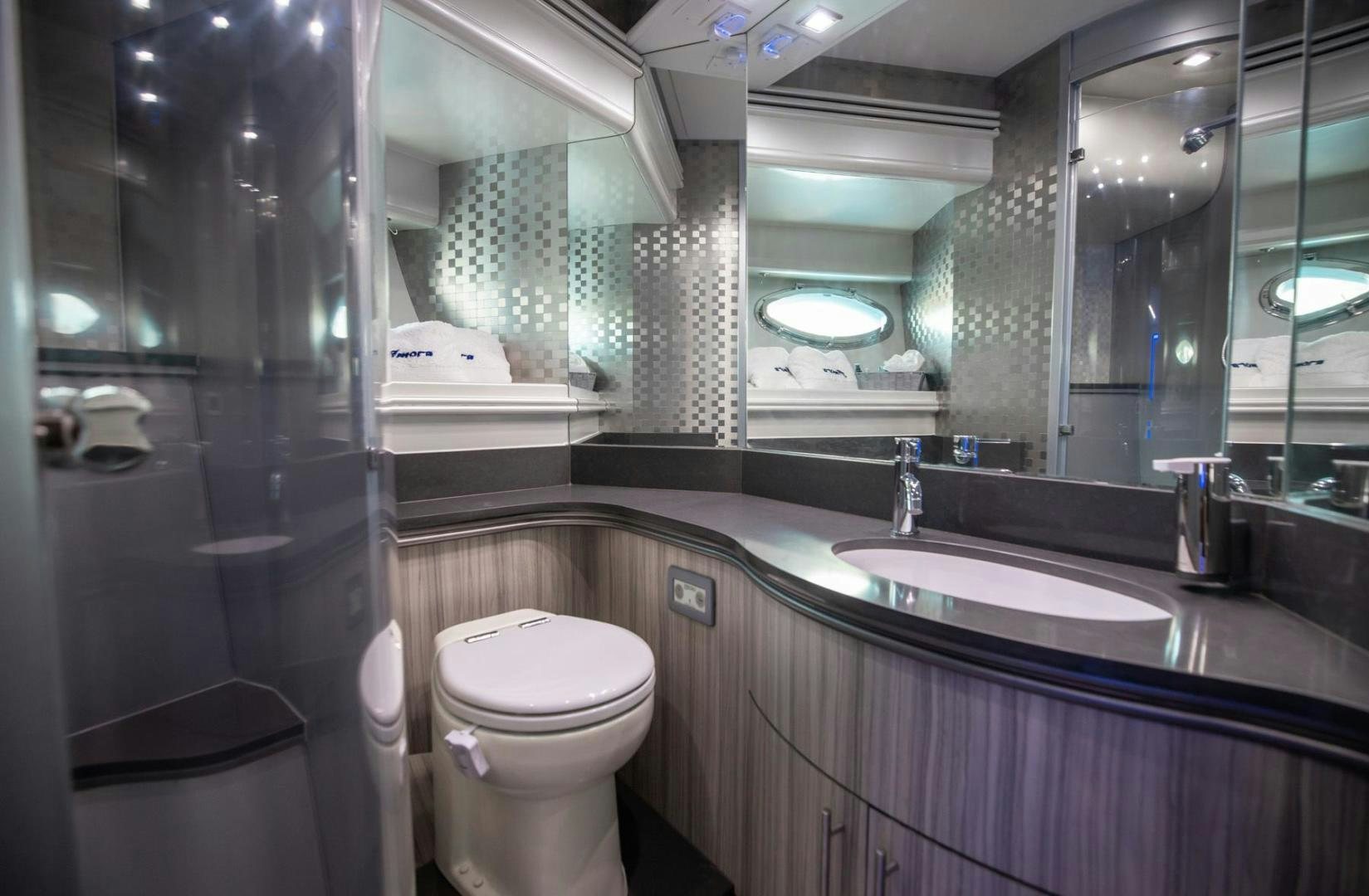 a bathroom with a large mirror aboard AMORA Yacht for Sale