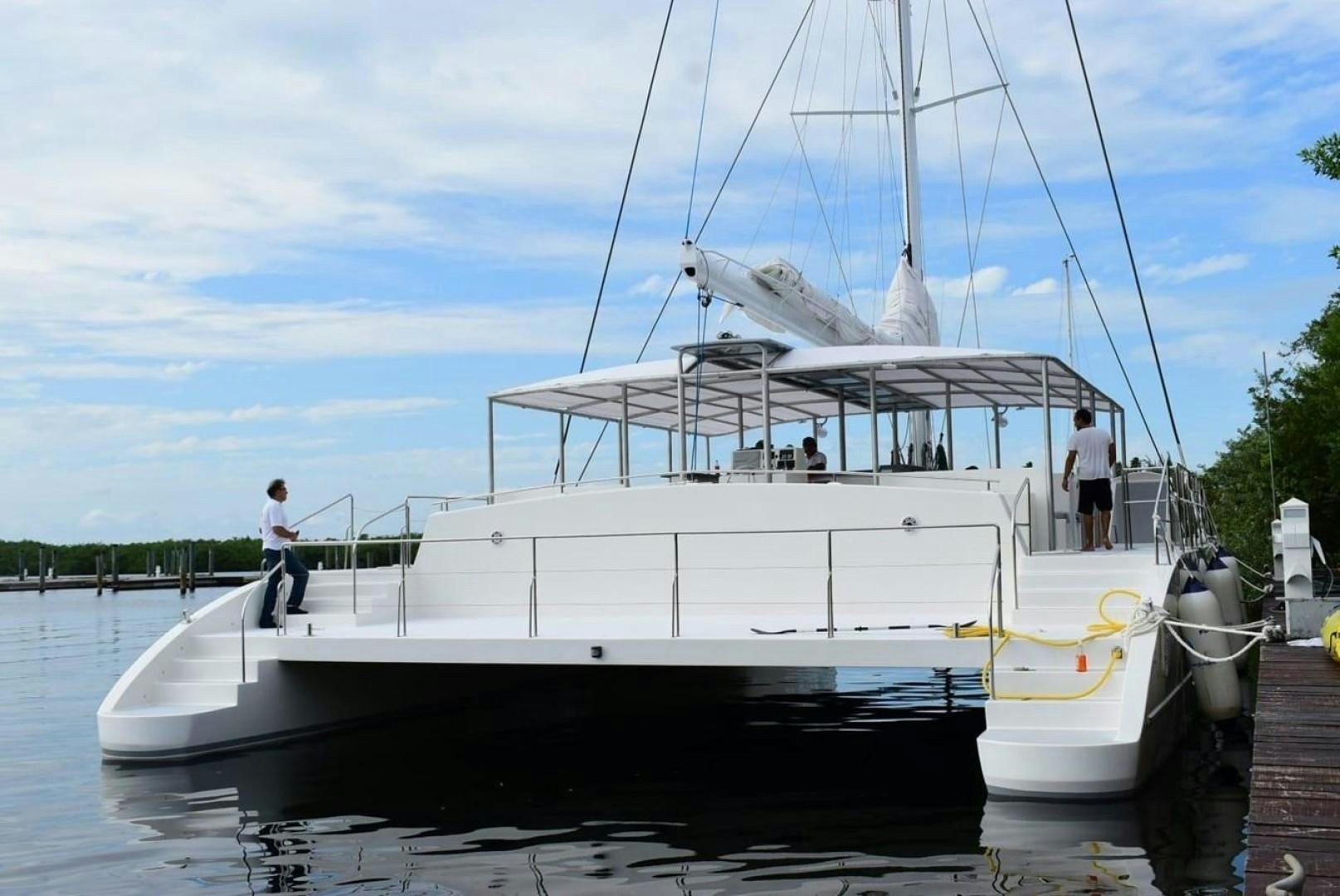 a boat docked at a pier aboard COMPASS Yacht for Sale