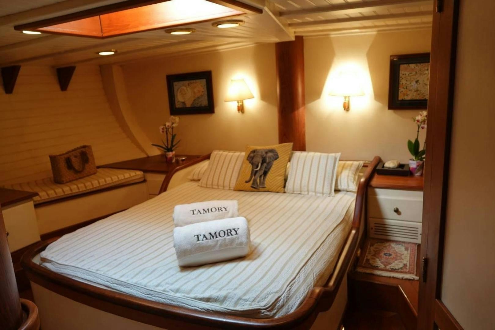 a hotel room with a bed and a table aboard TAMORY Yacht for Sale