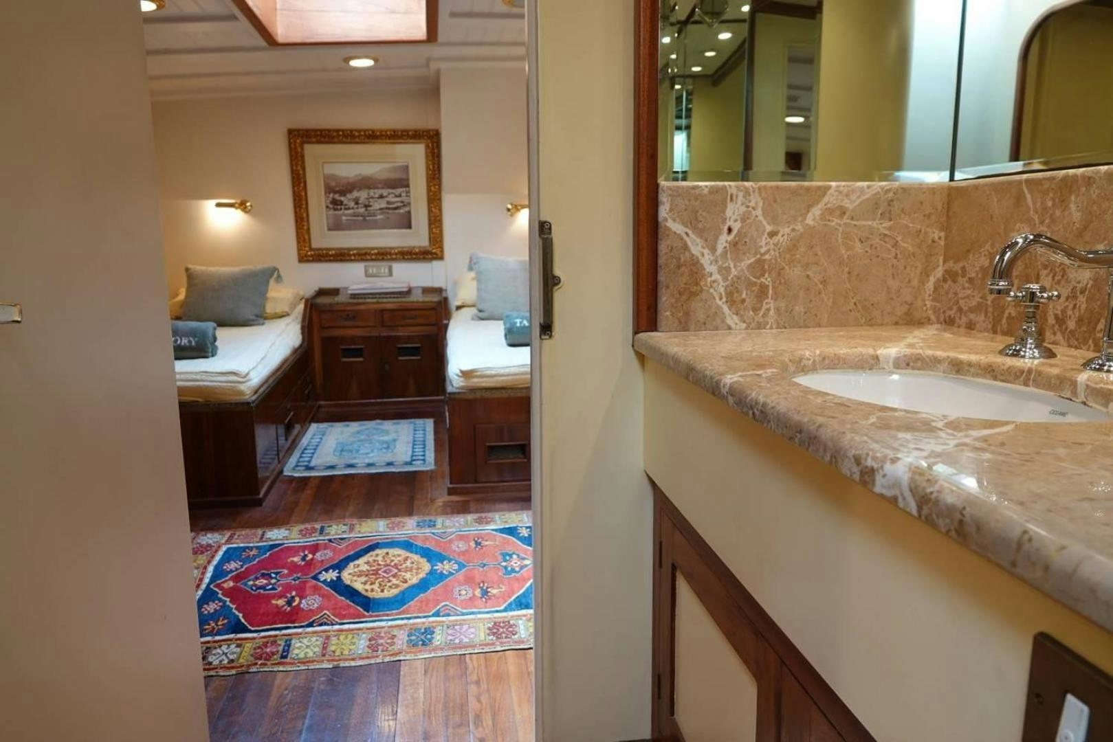 a bathroom with a sink and a bed aboard TAMORY Yacht for Sale