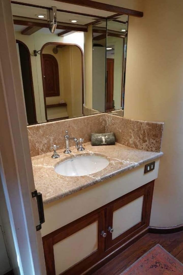 a bathroom with a sink and a mirror aboard TAMORY Yacht for Sale