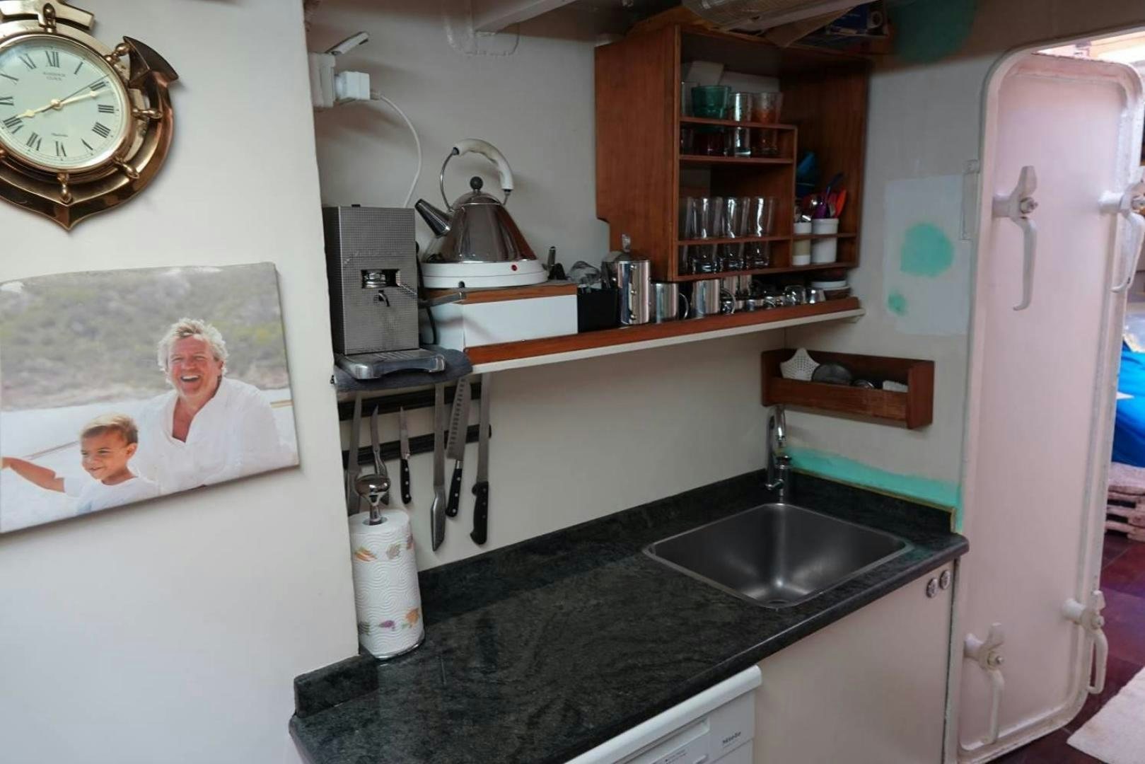 a kitchen with a sink and a clock aboard TAMORY Yacht for Sale