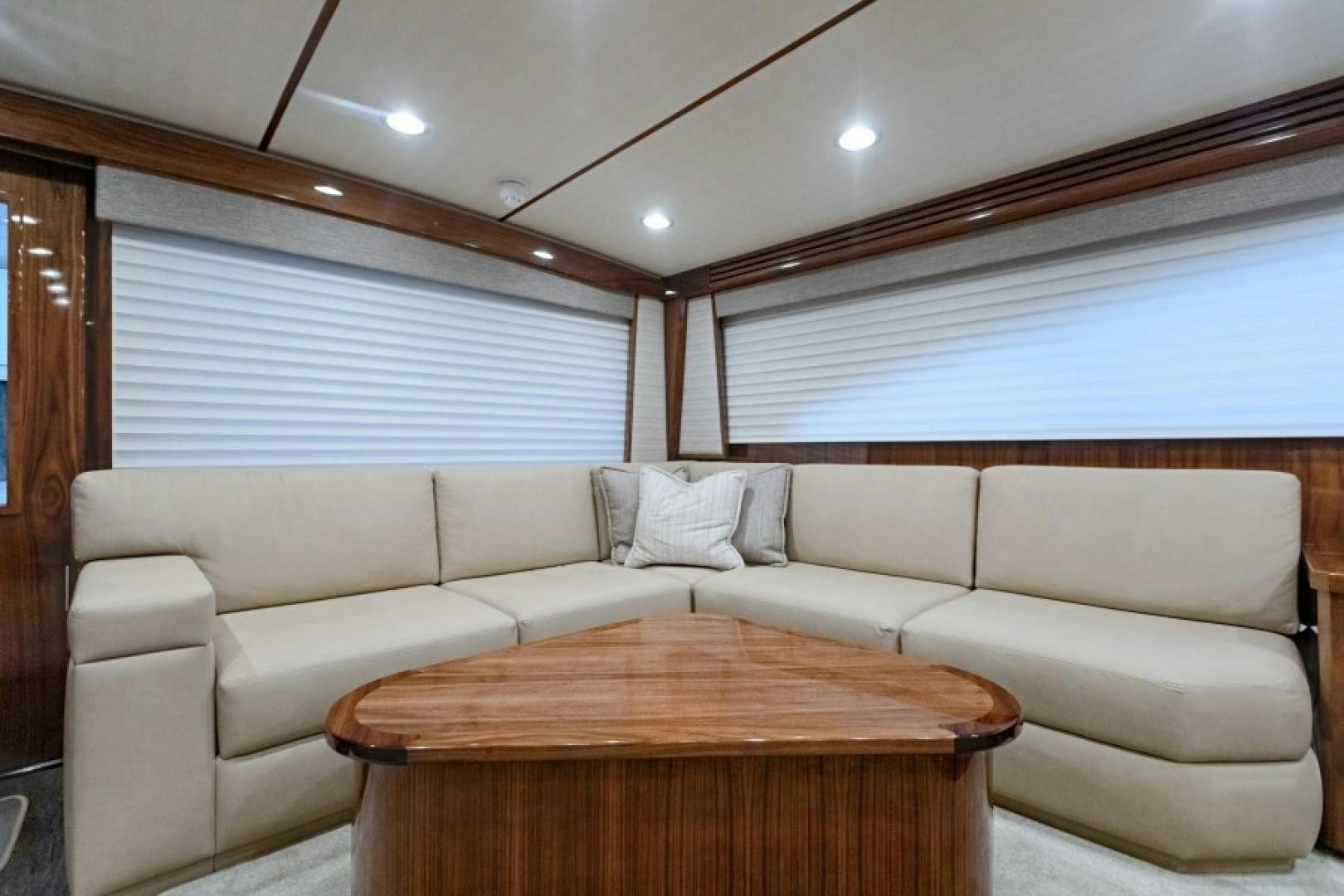a living room with a couch and a table aboard REEL GOOD TIME Yacht for Sale