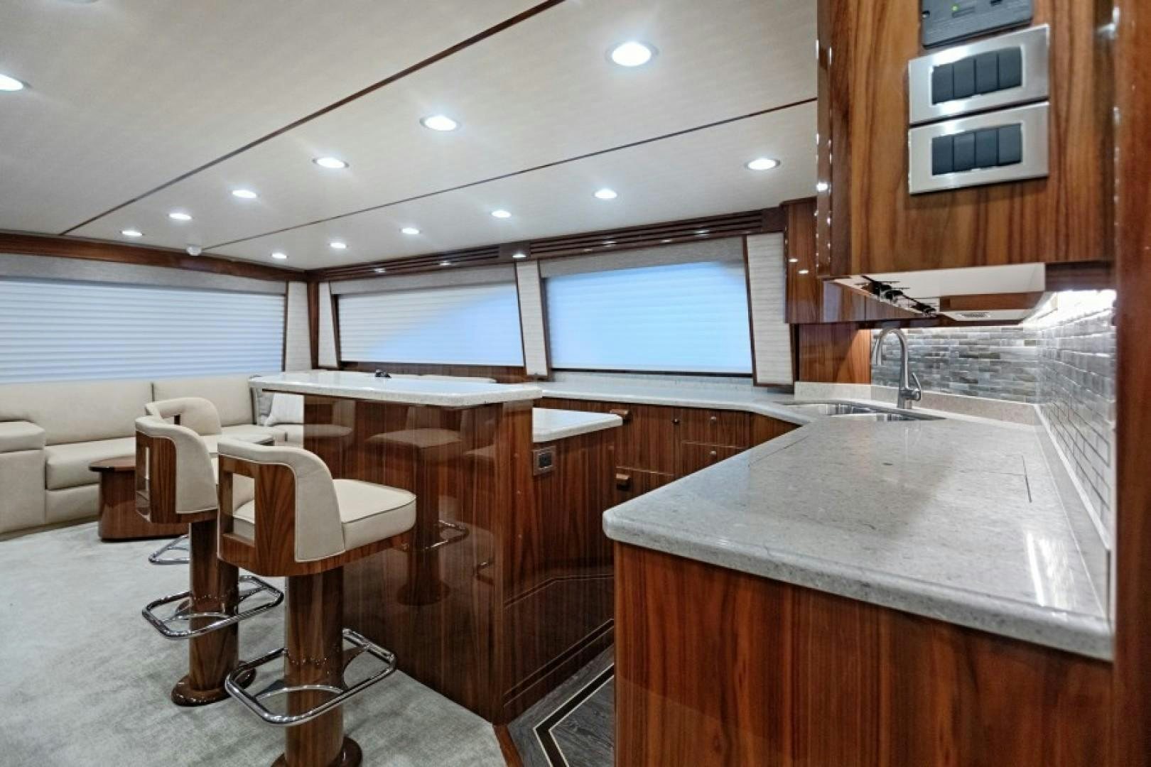 a kitchen with a bar and a table aboard REEL GOOD TIME Yacht for Sale