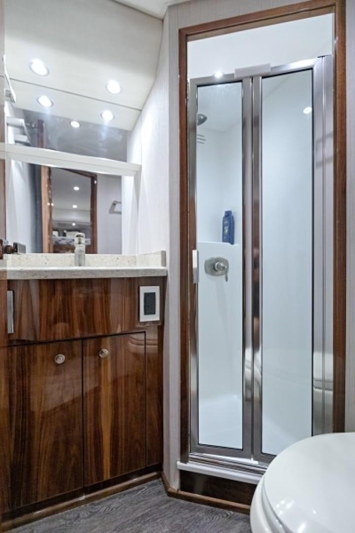 a bathroom with a glass shower aboard REEL GOOD TIME Yacht for Sale