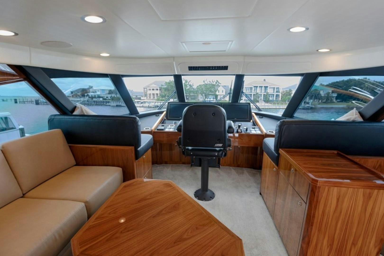 inside of a car with a table and chairs and a tv on the table aboard REEL GOOD TIME Yacht for Sale