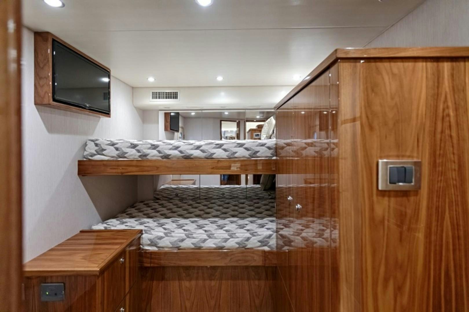 a room with a bed and a television aboard REEL GOOD TIME Yacht for Sale