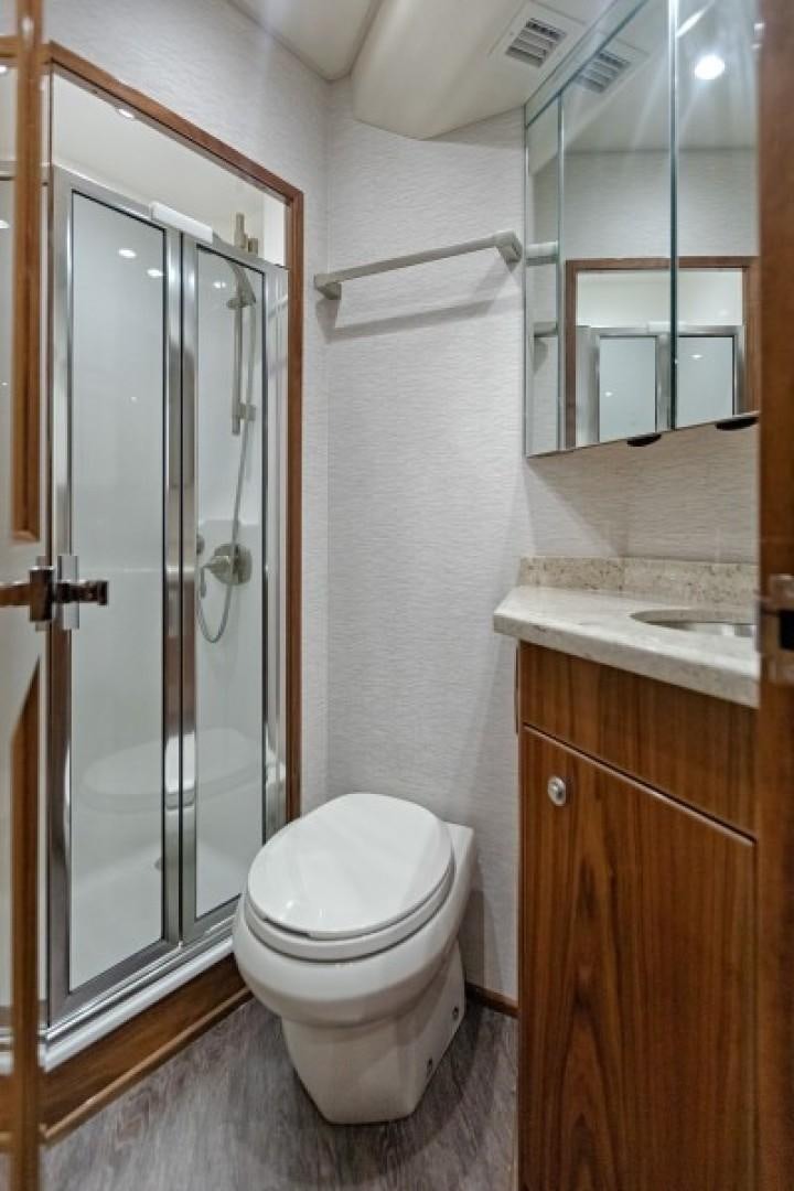 a bathroom with a glass shower door aboard REEL GOOD TIME Yacht for Sale