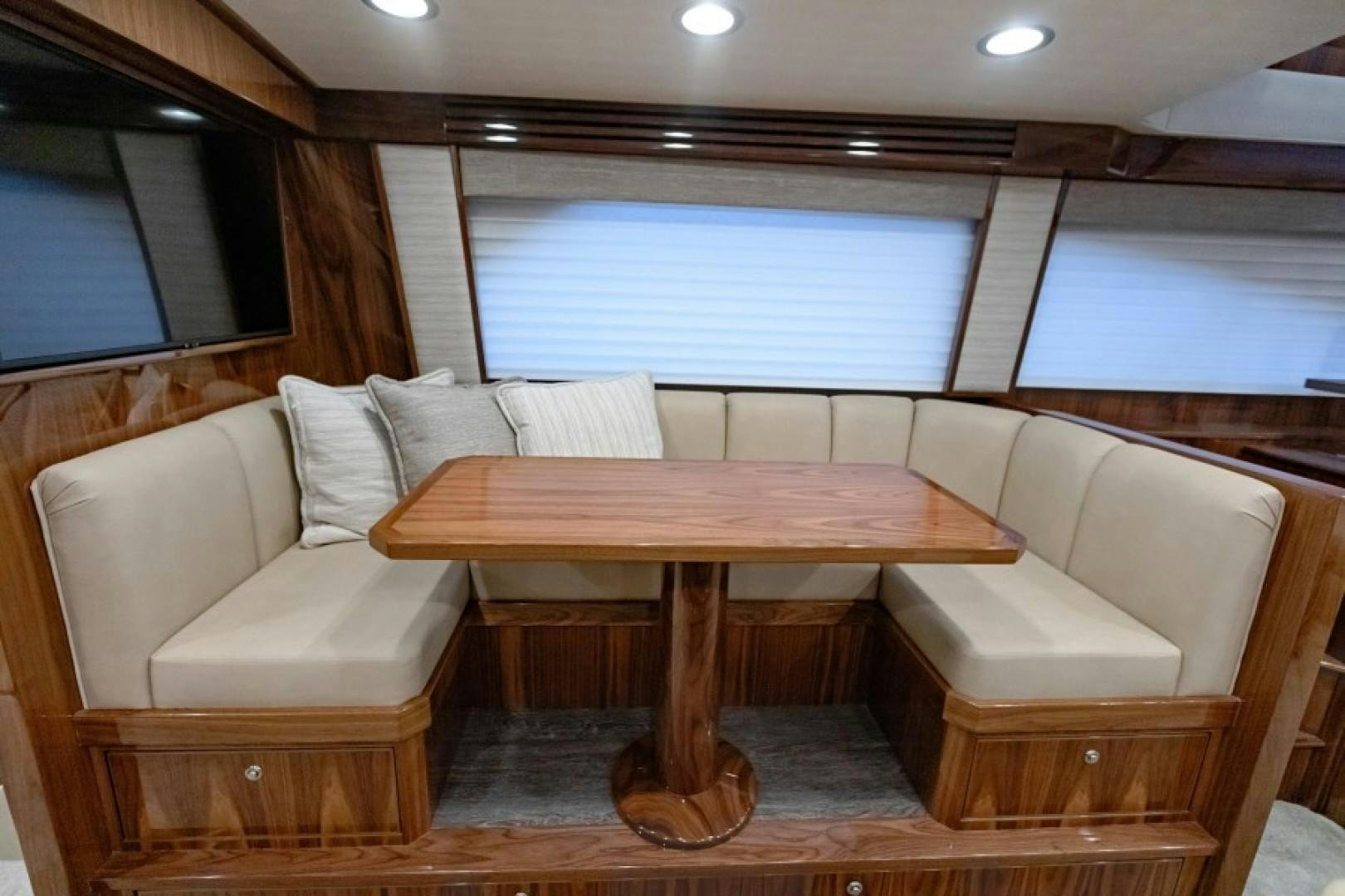 a room with a table and couches aboard REEL GOOD TIME Yacht for Sale