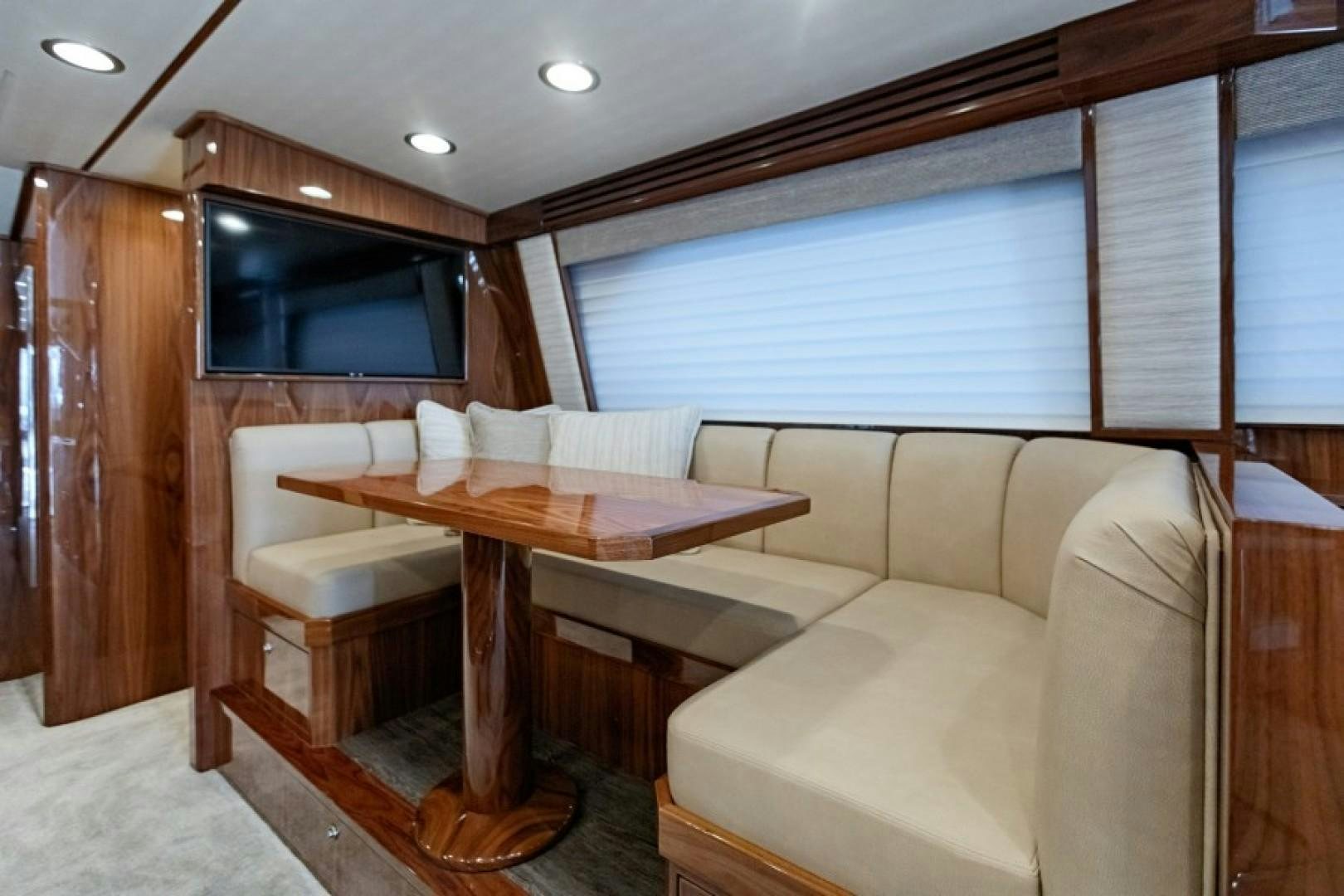a living room with a couch and a table aboard REEL GOOD TIME Yacht for Sale