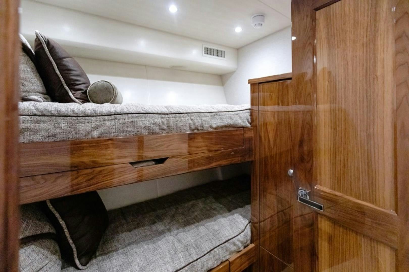 a bed with a wooden headboard aboard REEL GOOD TIME Yacht for Sale
