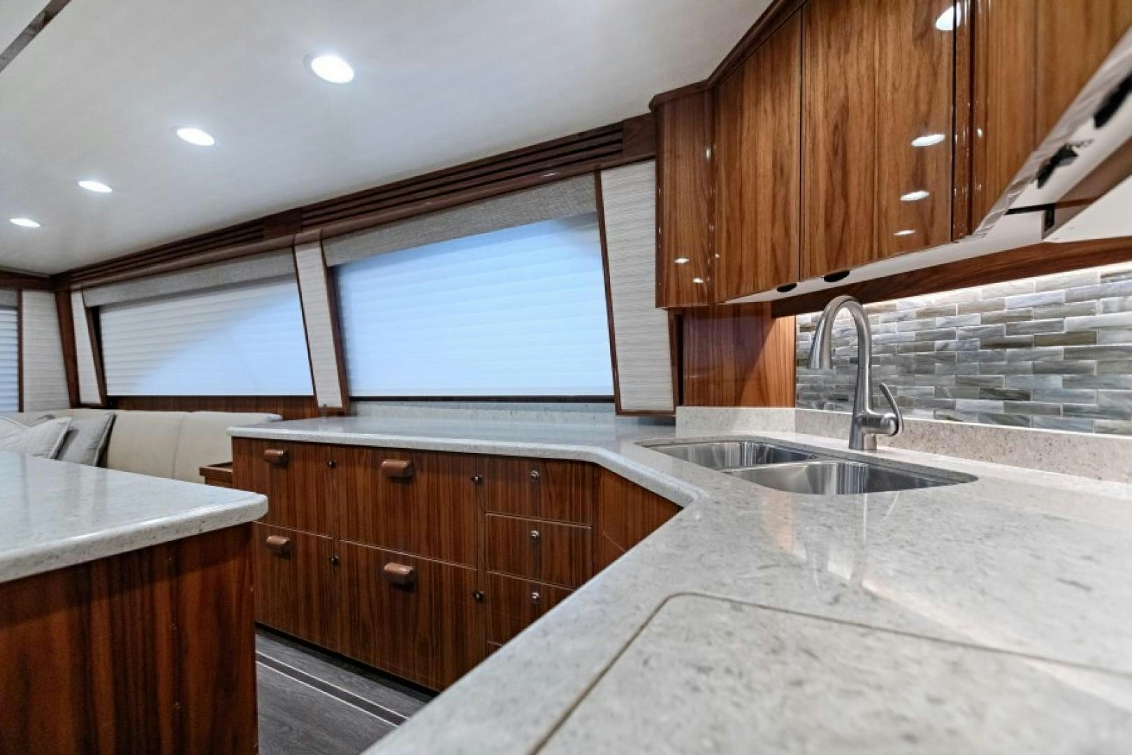 a kitchen with wooden cabinets aboard REEL GOOD TIME Yacht for Sale