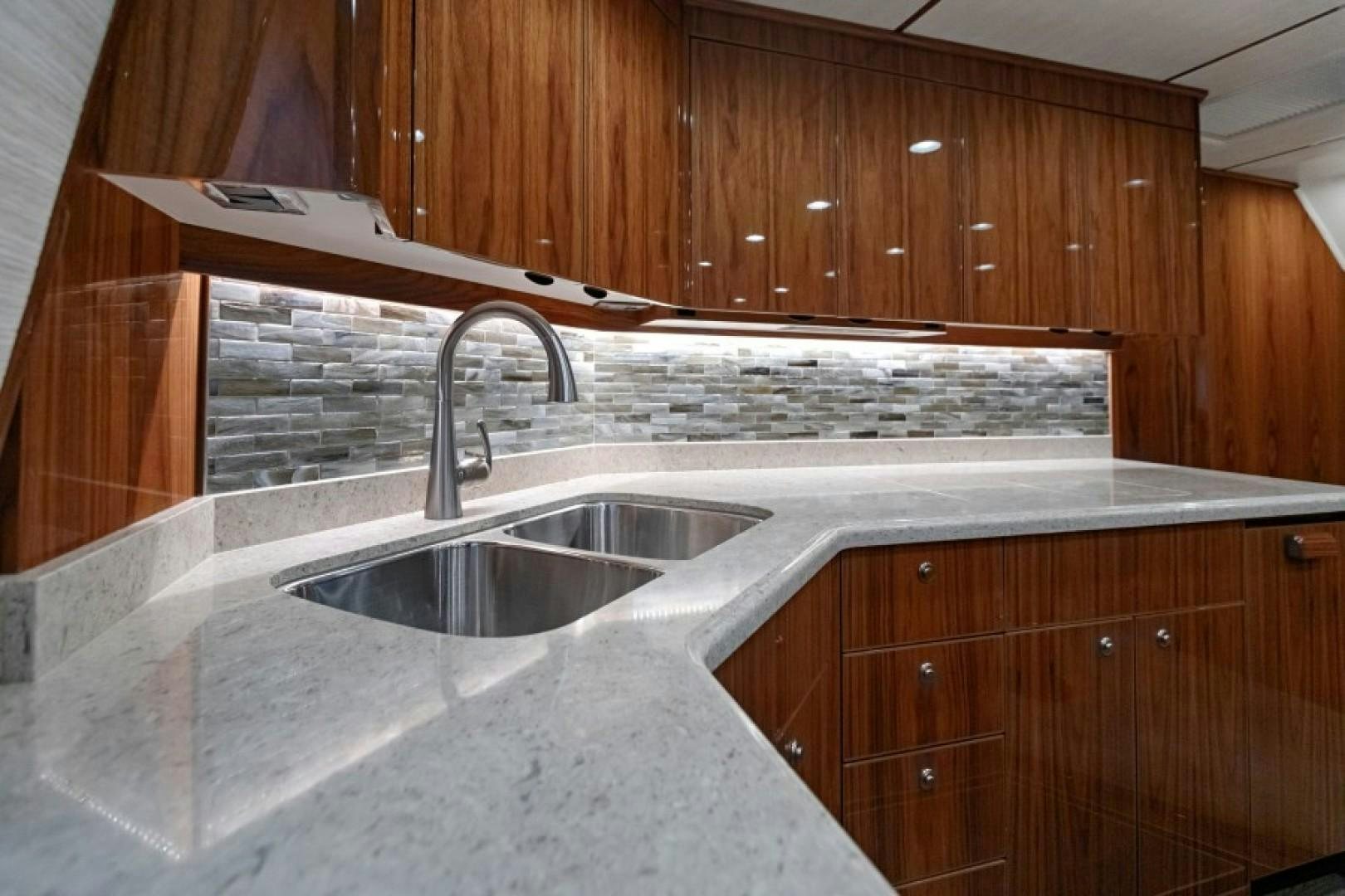 a kitchen with wooden cabinets aboard REEL GOOD TIME Yacht for Sale