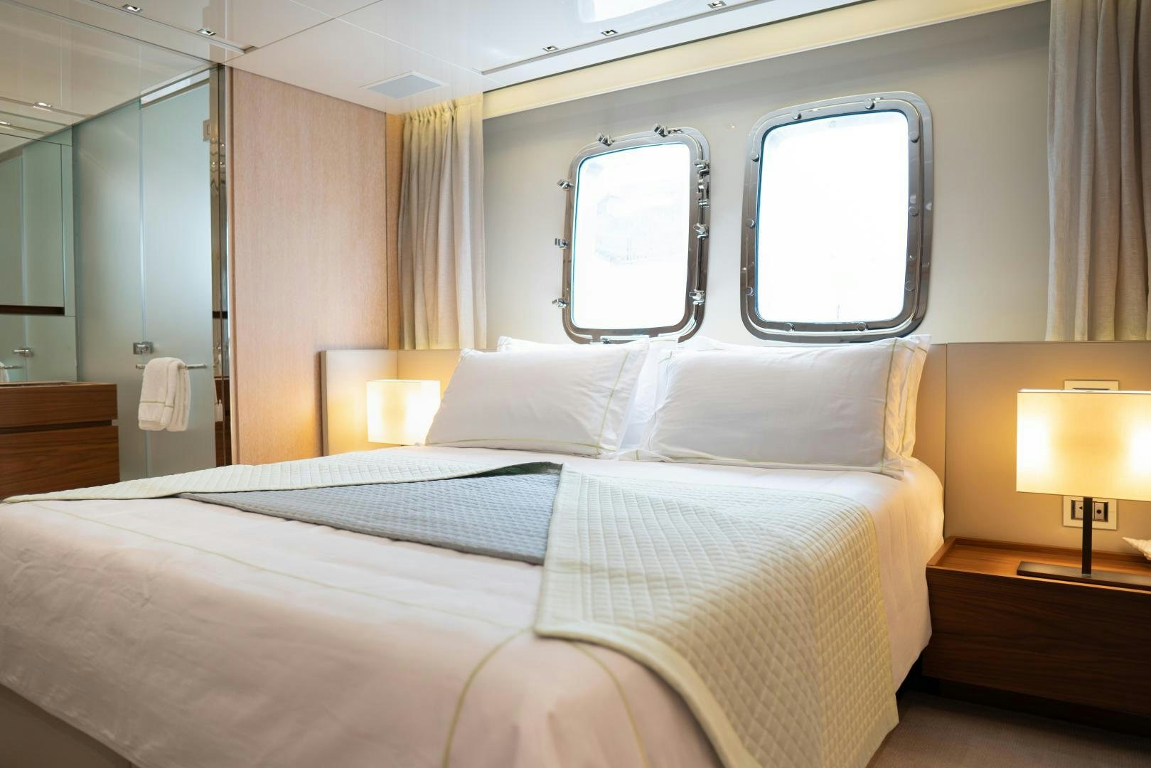 a bed with white sheets aboard BODACIOUS Yacht for Sale