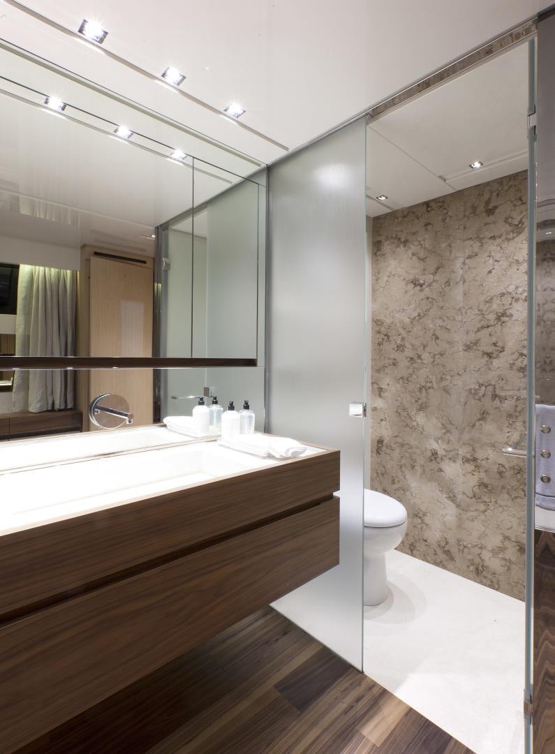 a bathroom with a glass shower aboard BODACIOUS Yacht for Sale